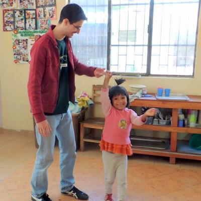 Early Childhood Development volunteer dancing with a child at his placement Projects Abroad Early Childhood Development volunteer dancing with a child during his spring break project placement